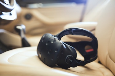 The HTC Vive headset resting on a car seat.