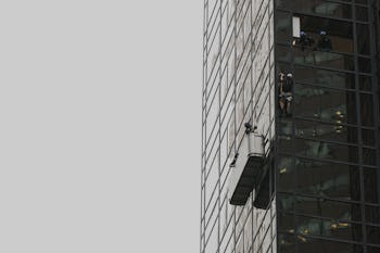 Steve, a climber, in a portable terrace on the Trump Tower