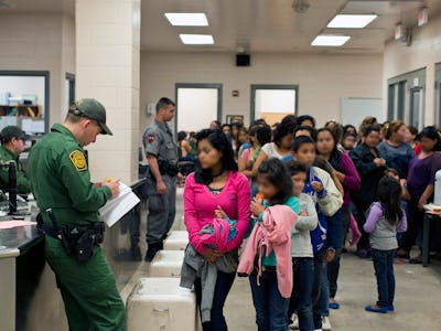 Police officers and kids in a school hallway