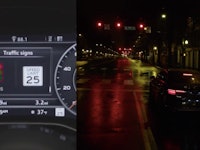 An audi dashboard next to the view of a street at night