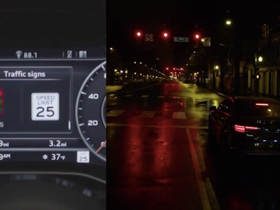 An audi dashboard next to the view of a street at night
