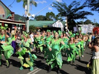 People marching down a street in weed-inspired clothes