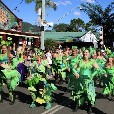 People marching down a street in weed-inspired clothes