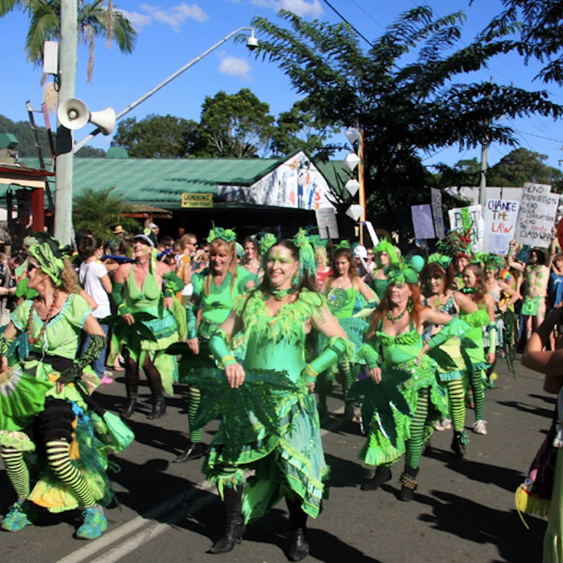 People marching down a street in weed-inspired clothes