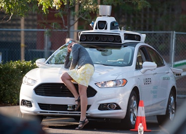 PITTSBURGH, PA - SEPTEMBER 22: A woman poses with an Uber driverless Ford Fusion as it sits in the U...