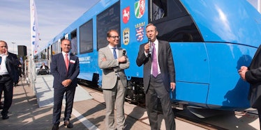 German politicians stand in front of a hydrogen-powered train developed by Alstom.