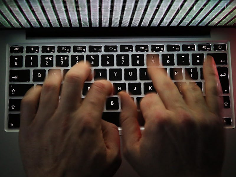 A closeup of a person typing something on a laptop keyboard