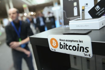 HANOVER, GERMANY - MARCH 16: A sign in French that reads: 'We accept bitcoins' hangs at a display of...