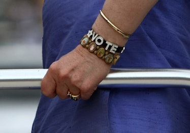 Hillary Clinton wearing a bracelet that says "vote"