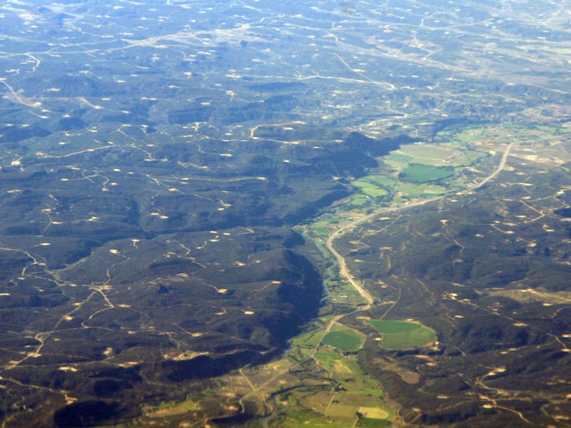 An aerial shot of a landscape of the Southwest with giant methane plumes