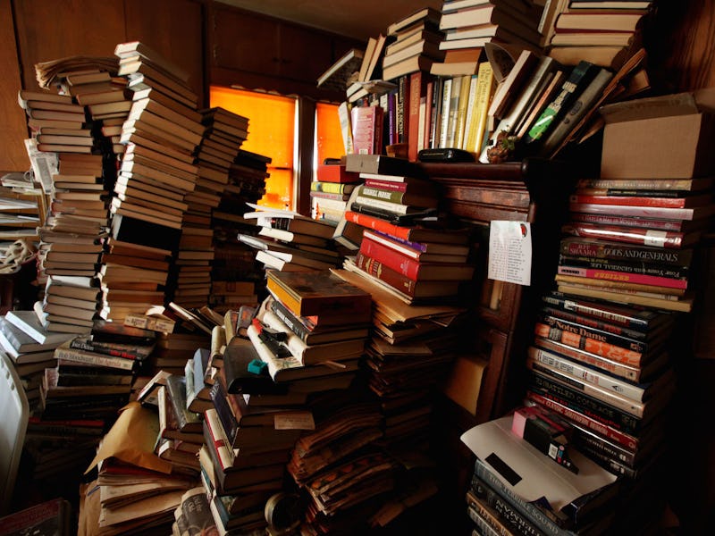 Multiple stacks of bad books that became great movies in a dark room
