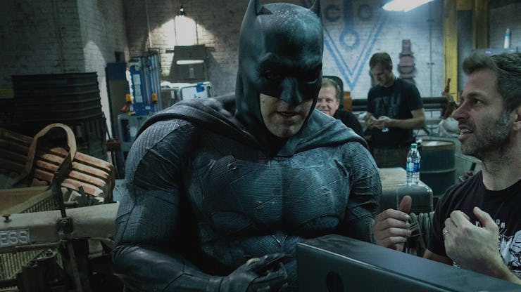 Ben Affleck in a Batman costume standing next to Zack Snyder