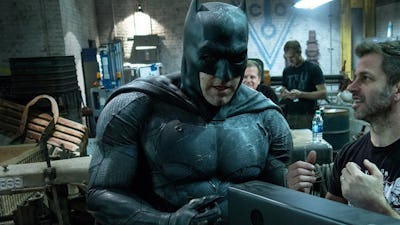 Ben Affleck in a Batman costume standing next to Zack Snyder