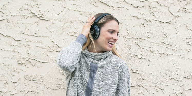 A woman smiling while wearing the T7 Blast High Fidelity Bluetooth Headphones