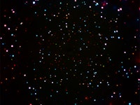 A dark sky with lots of visible stars glowing