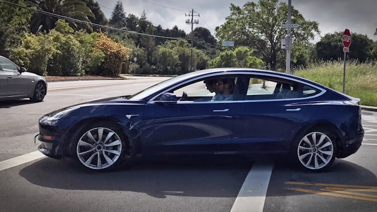 The blue Model 3 out on the road.