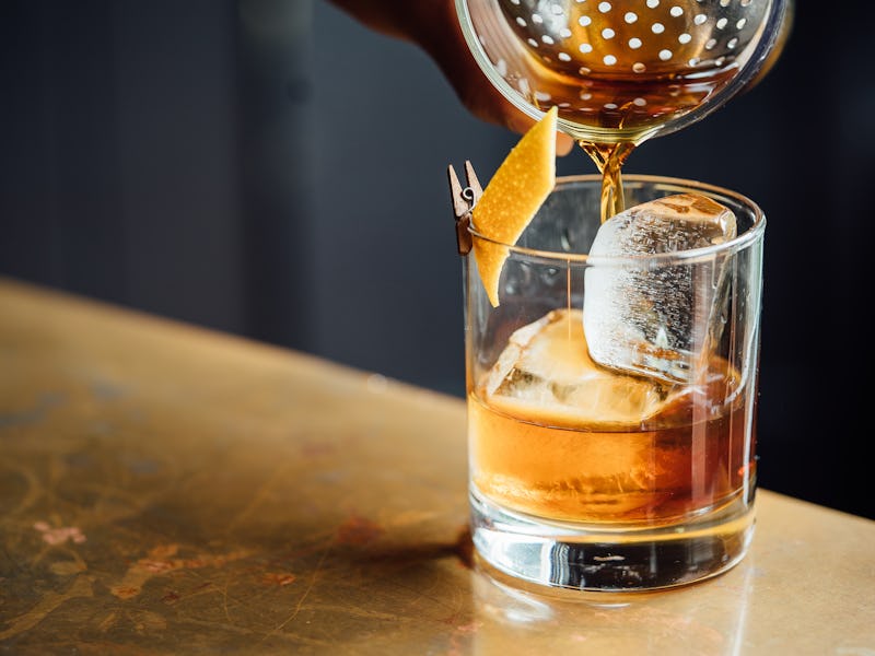 A whiskey on the rocks being prepared