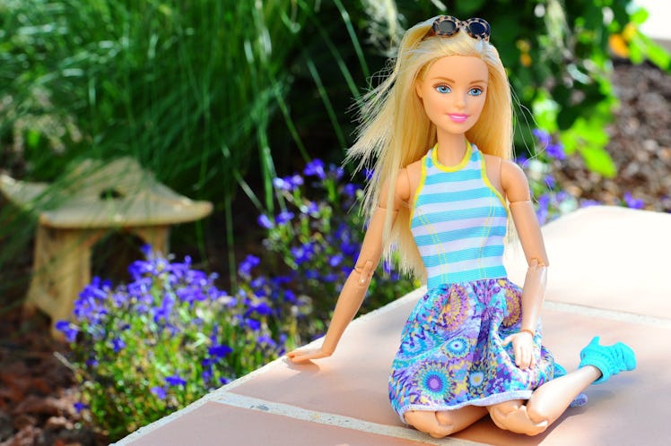 Barbie sitting in garden.
