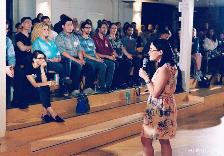 Cherry Rose Tan holding a microphone during her speech