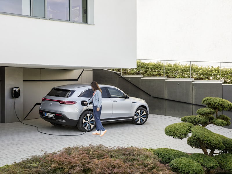 A house in a electric-car friendly country with an electric-car parked in front of it
