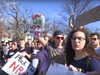 A group of students fighting for gun reform during protest while holding posters