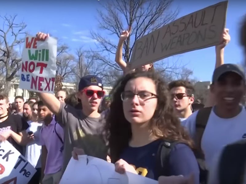 A group of students fighting for gun reform during protest while holding posters