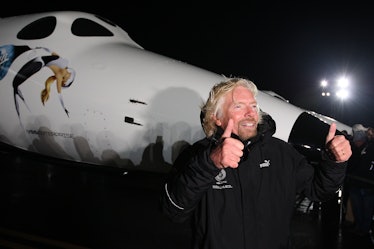 Sir Richard Branson gestures to reporters as Virgin Galactic unveils its new SpaceShipTwo spacecraft...
