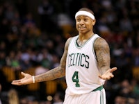 Isaiah Thomas in a Celtics jersey and a white headband with his arms open  