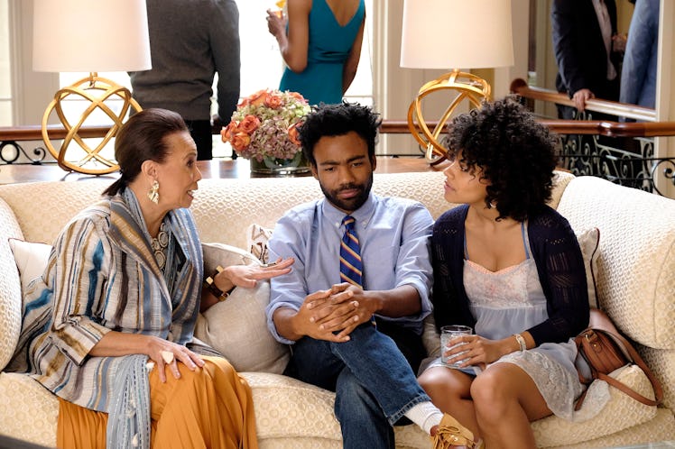 Donald Glover as Earnest Marks and Zazie Beets as Vanessa Keefer sitting on the sofa