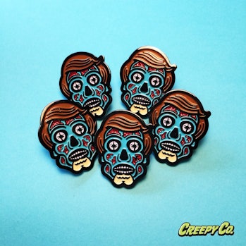 Creepy Co.'s 'All Consuming Alien" pin design based on John Carpenter's 'They Live.'