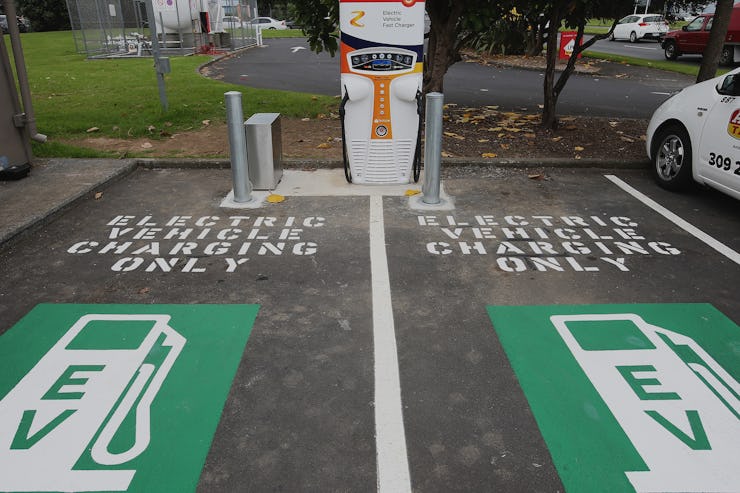 Two parking lot sections with "Electric Vehicle Charge Only" signs for emission-free cars