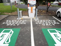 Two parking lot sections with "Electric Vehicle Charge Only" signs for emission-free cars