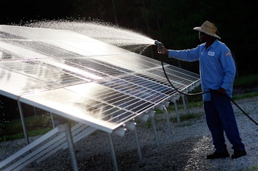 Kindrell Hutchinson washes off a solar panel system at the Leveda Brown Environmental Park and Trans...