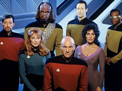 The cast from Star Trek posing together in their costumes