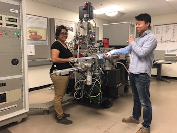 Bose (left) and Jin (right) load asteroid samples into a secondary ion mass spectrometer.