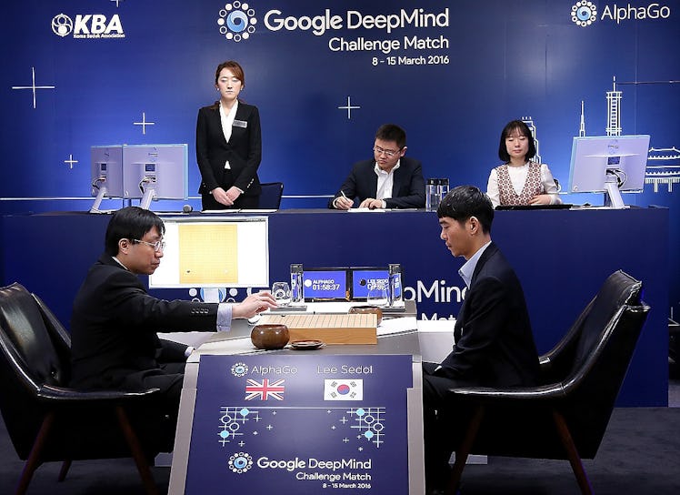 South Korean professional Go player Lee Sedol watches as Google DeepMind's lead programmer Aja Huang...