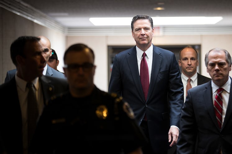 James Comey leaving a room after a meeting session