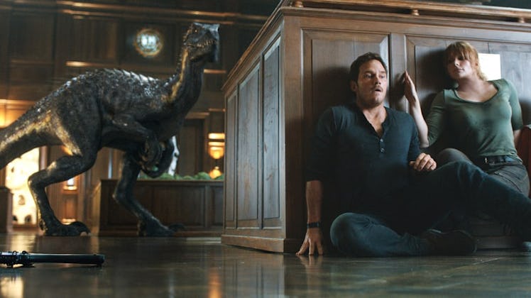 Owen and Claire play a silly game by sliding around a platform to hide from the Indoraptor. 