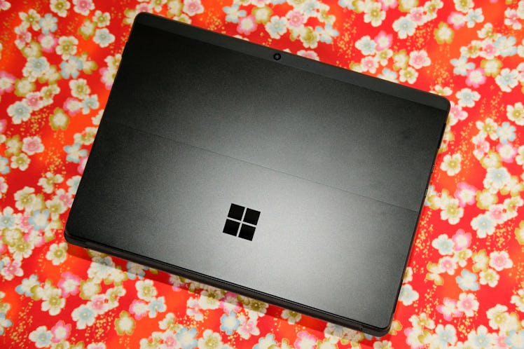 Closed Microsoft Surface Pro X laptop laid down on the surface