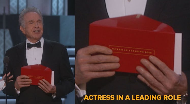 Warren Beatty holding a red envelope with "actress in a leading role" text on it