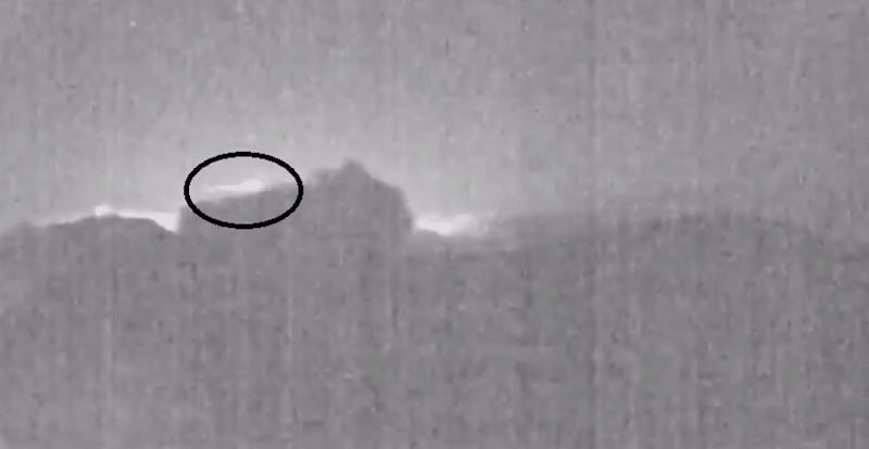 A screenshot of a video that shows a meteor soaring behind an erupting volcano in Costa Rica