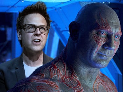 James gunn standing behind dave bautista as draxx