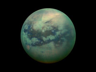 Titan, Saturn's largest moon with darkness all around it 