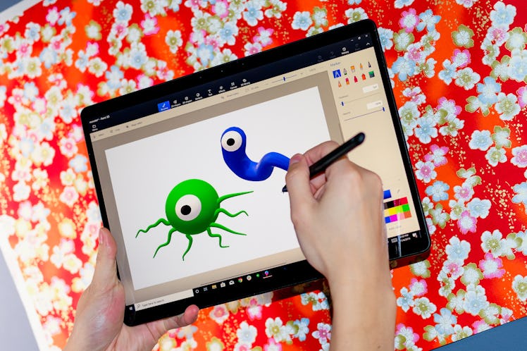 A kid drawing on the Microsoft Surface Pro X