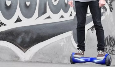 Blue Jetson All-Terrain Hoverboard and a boy riding it