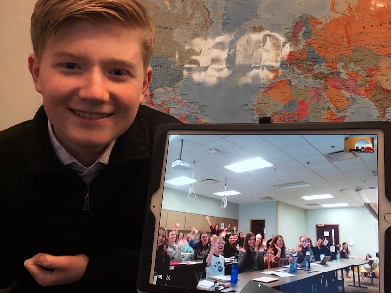 14 year-old alex knoll sitting in front of a map of the world holding open a laptop with an ongoing ...