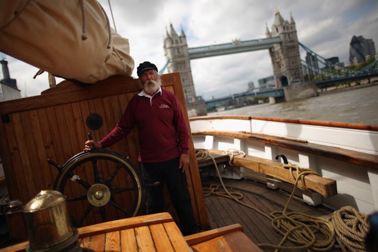 A man driving the "Irene" ship on the River Thames in London