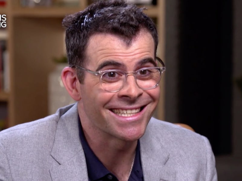 Adam Mosseri smiling in a grey blazer and black shirt