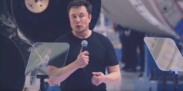 Elon Musk holding a microphone