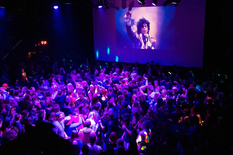 MINNEAPOLIS, MN - APRIL 21: Guests dance to Prince music as a slide show flashes images of the artis...